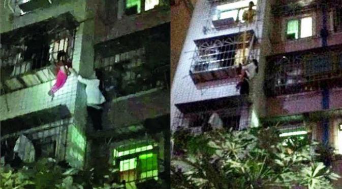 Saat itu jam 9 malam saat seorang anak terperangkap di jendela kamar apartemennya. (foto: Shanghaiist)