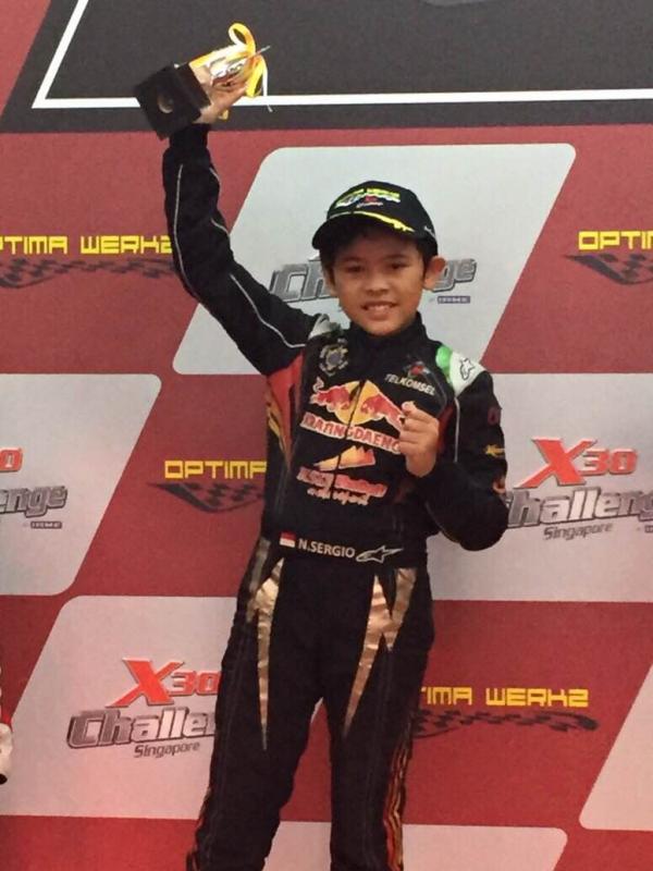 Sergio Noor tunjukkan trofi usai rebut podium di kejuaraan karting X30 Challenge di Singapura (istimewa)