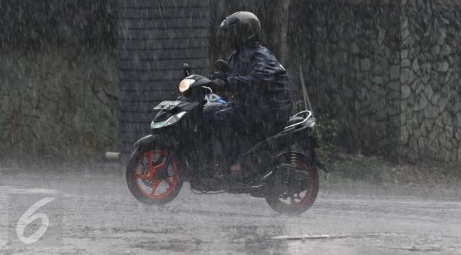 Warga menerobos hujan yang mengguyur kawasan Pondok Labu, Jakarta Selatan, Rabu (2/12). (Liputan6.com/Immanuel Antonius)sat