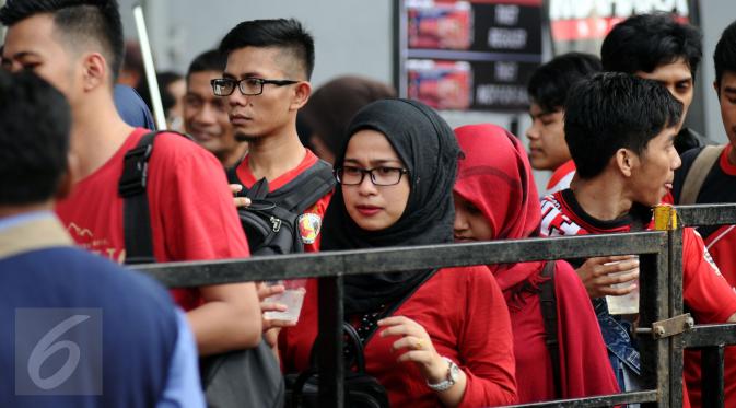 Salah satu suporter Semen Padang wanita terjebak antrian saat memasuki areal Stadion GBK Jakarta, Minggu (24/1/2016). Semen Padang akan melawan Mitra Kukar dalam laga final Piala Jenderal Sudirman.
