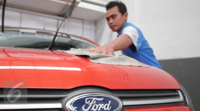 Petugas mengelap mobil Ford di salah satu dealer di Jakarta, Selasa (26/1). Ford memastikan konsumen dapat tetap mengunjungi dealer Ford untuk layanan penjualan, servis dan garansi hingga beberapa waktu ke depan di tahun ini. (Liputan6.com/Angga Yuniar)