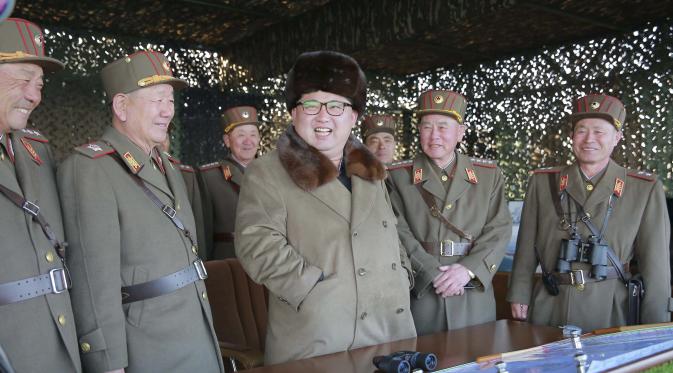 Kim Jong-un tersenyum usai menyaksikan latihan militer prajuritnya, Korea Utara, Jumat (25/3). (Reuters/KCNA)