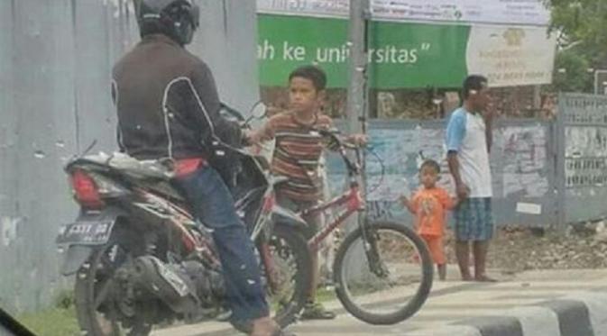 Bocah ini tak kenal takut menghadang motor-motor yang naik trotoar (istimewa)