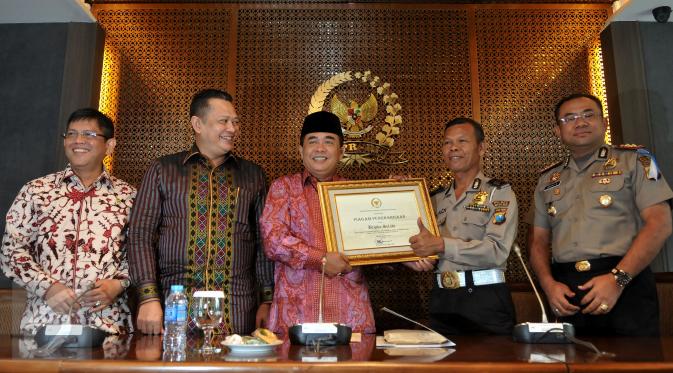 Ketua DPR Ade Komarudin (ketiga kiri) memberikan penghargaan kepada Brigadir Kepala (Bripka) Seladi, anggota Polres Malang Kota yang menjalani pekerjaan sampingan sebagai pemulung, di Gedung Parlemen, Jakarta, Senin (23/5). (Liputan6.com/Johan Tallo)