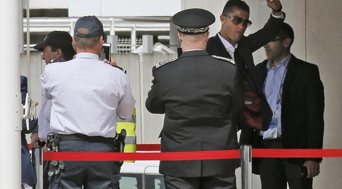 Cristiano Ronaldo melambaikan tangan ke arah fans Portugal di bandara Orly (Reuters)