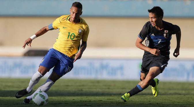 Kapten Brasil, Neymar, menggiring bola berusaha melewati pemain Jepang, Riki Harakawa, pada laga ujicoba jelang Olimpiade 2016 Rio Janeiro di Goiania, Brasil, Minggu (30/7/2016). Brasil menang 2-0 atas Jepang. (AP/Eraldo Peres) 
