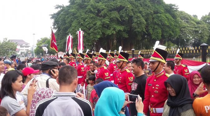 Warga selfie saat seremoni pergantian pasukan jaga Istana Kepresidenan dalam Car Free Day (CFD) di seputar Medan Merdeka Barat, Jakarta, Minggu (28/8/2016). (Delvira Hutabarat/Liputan6.com)