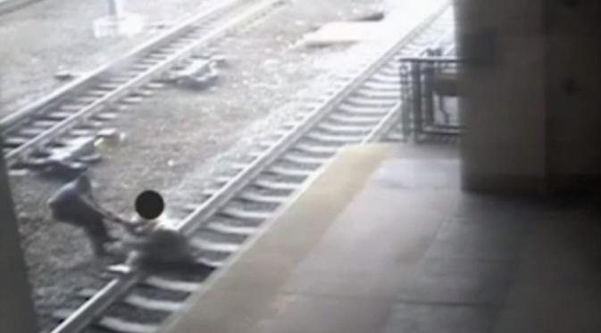 Ortiz saat berusaha menolong seorang pria yang mencoba bunuh diri di rel kereta. | via: thesun.co.uk