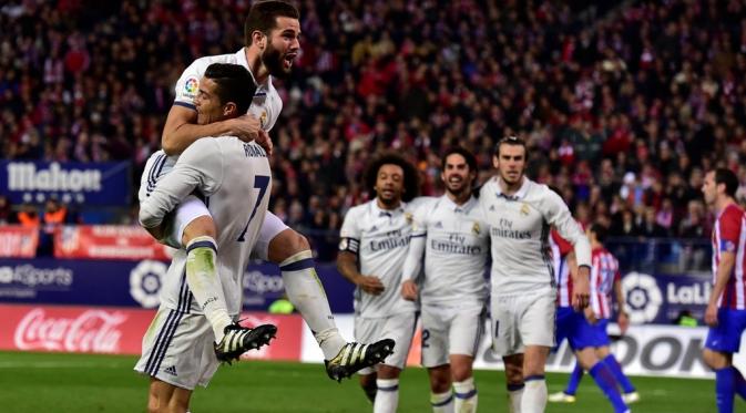 Pemain Real Madrid merayakan gol yang dicetak Cristiano Ronaldo ke gawang Atletico Madrid pada laga pekan ke-12 La Liga Spanyol di Estadio Vicente Calderon, Sabtu (19/11/2016). (AFP/Gerard Julien)