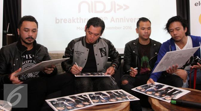 Band Nidji tengah menandatangani sampul album vinyl bertajuk Breakthru. Album Breakthru dirilis ulang dalam rangka peringatan 10 tahun album tersebut. (Foto: Herman Zakharia/Liputan6.com)