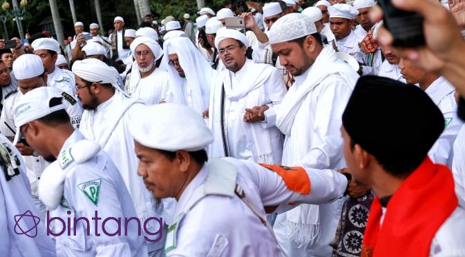 Sambil meneriakan takbir ribuan massa yang ikut demo 2 Desember menyambut datangnya Habib Rizieq di Monas. (Bintang.com/Adrian Putra)