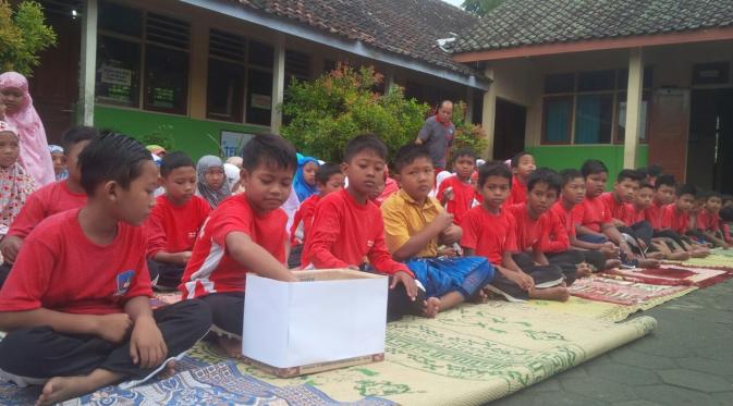 Murid SD di Gunungkidul panjatkan doa dan kirim koin bagi korban Aceh. (Liputan6.com/Yanuar H)