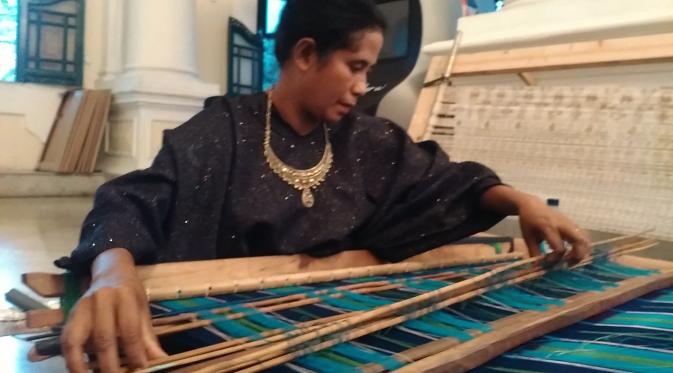 Mama Hermina sedang menenun kain tenun ikat untuk pria dalam pameran Pesona Kain dan Budaya Ende