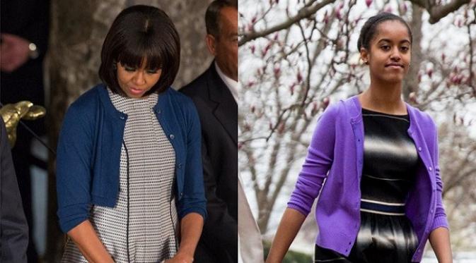 Malia Obama mengenakan cardigan serupa dengan ibunya, Michelle Obama. Sumber: popsugar.com.