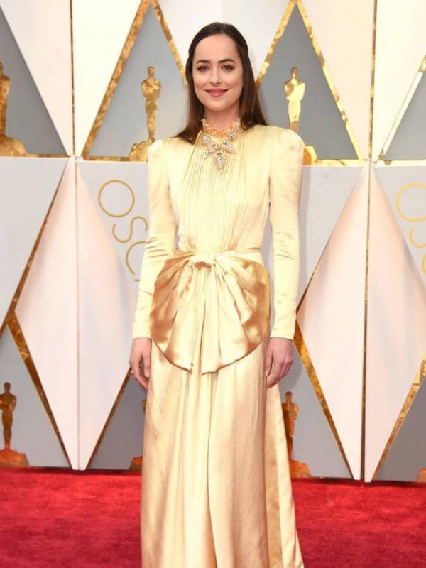 Dakota Johnson kenakan gaun warna gold, mirip patung Oscar? (foto: Eonline)