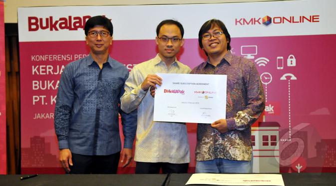 CEO EMTEK Group Sutanto Hartono (kiri),  CEO KMK Adi Sariaatmadja (tengah) dan CEO Bukalapak Achmad Zaky (kanan) menunjukkan dokumen kerjasama antara Bukalapak.com dengan PT.KMK Online, Jakarta, Rabu (4/1/2015). (Liputan6.com/Panji Diksana)