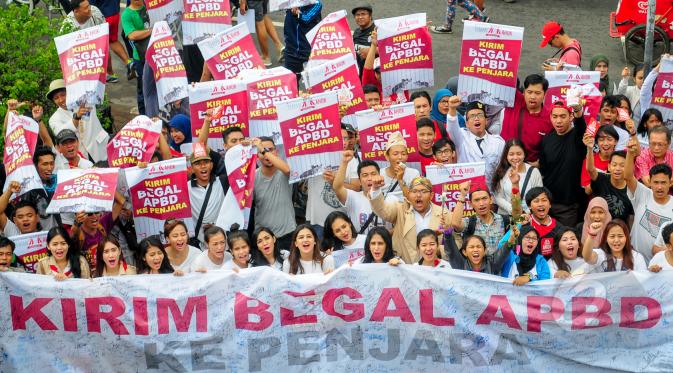 Kelompok masyarakat yang menamakan diri @temanahok menggelar aksi galang petisi 'Kirim Begal APBD Ke Penjara' di depan Bundaran HI atau arena Car Free Day, Jakarta, Minggu (8/3/2015). (Liputan6.com/Yoppy Renato) 