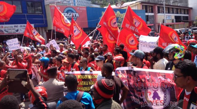 PROTES - Ratusan Persipura Mania kompak mengenakan busana serba merah saat aksi damai di halaman Kantor DPR Papua, Selasa (26/5/2015). Aksi ini sempat membuat kemacetan panjang. (Liputan6.com / Katharina Janur)