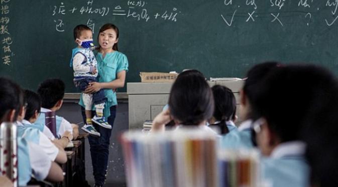 Zhang Wei saat mengajar kelas kimia sambil menggendong Tutu/stomp.com