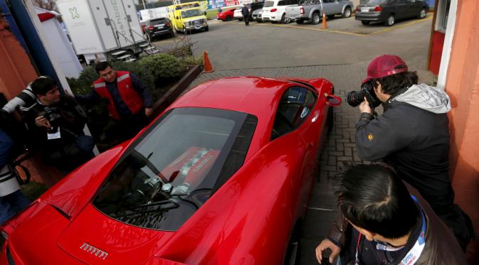 Gelandang Chile, Arturo Vidal saat berada didalam mobil ferrari miliknya saat tiba untuk menghadiri sesi latihan bersama timnas Chile yang bermain dalam Copa America 2015, (9/6/2015). (REUTERS/Ivan Alvarado)