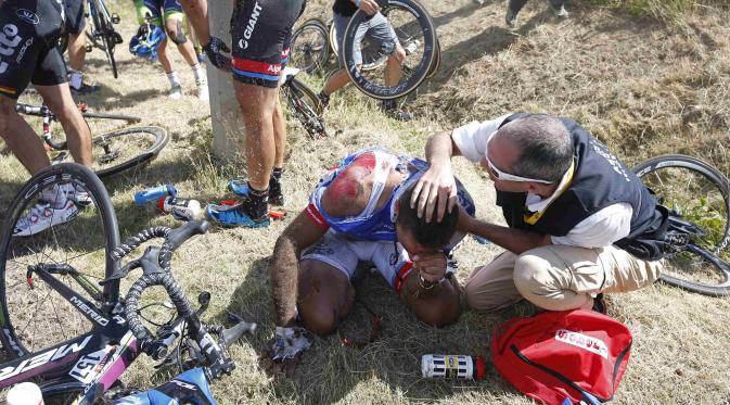 Pembalap sepeda asal Prancis,William Bonet mendapatkan perawatan setelah menjadi korban kecelakaan di etape 3 Tour de France (REUTERS/Eric Gaillard)