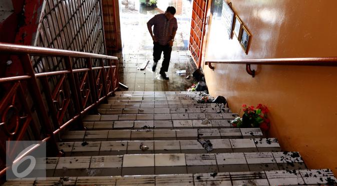 Petugas sekolah SMPN 49 melihat ruangan perpustakaan dan gudang yang terbakar, Jakarta, Kamis (3/9/2015). Kebakaran diduga berasal dari korsleting dan melahap tiga ruangan sekolah.(Liputan6.com/Yoppy Renato)