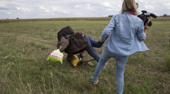 Juru kamera perempuan dari stasiun televisi Hungaria, N1TV menendang pengungsi Suriah (Reuters)