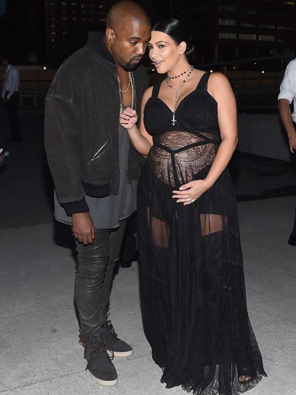 Kim Kardashian bersama suaminya, Kanye West tampak berbincang saat menghadiri Givenchy Spring/Summer 2016 pada acara New York Fashion Week di New York, Jumat (11/9/2015). (Michael Loccisano/Getty Images/AFP)